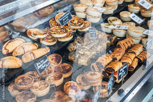 Deli window display, showing a selection of savoury pastries in Southwold, Suffolk, UK