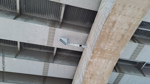 Close-up of steel bridge girders with hydraulic shock transmission unit and expansion joint
