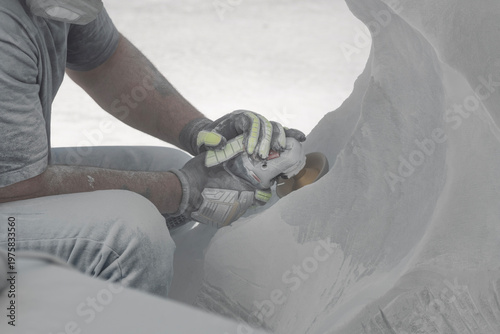 Craftsman working on classical stone statue close up