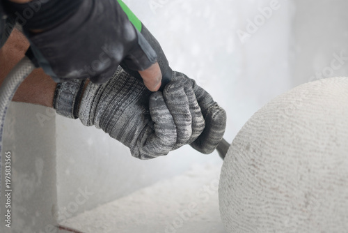 Artist shaping marble sculpture detail in studio