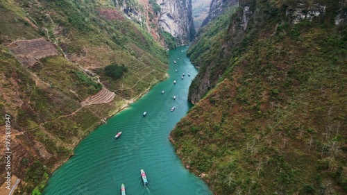 Wallpaper Mural Aerial drone footage of Nho Que River flowing through Tu San Canyon with towering limestone cliffs turquoise water small boats and a deep mountain gorge in northern Vietnam Torontodigital.ca