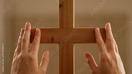Hands Placing Touch on Wooden Cross Symbolizing Faith and Reflection