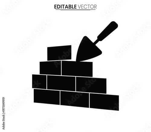 Black silhouette of a brick wall with a trowel resting on top silhouette