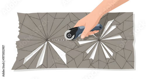 Hand using rotary cutter on gray geometric patterned fabric