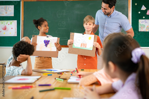 Art teacher praising diverse elementary students presenting their drawings