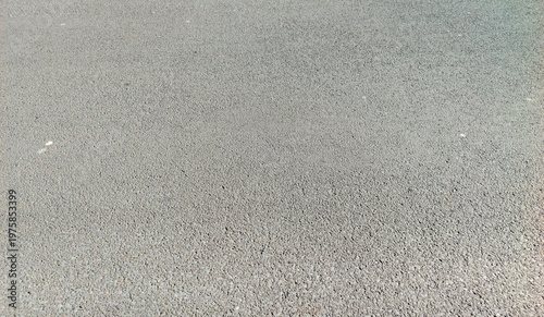 close up of gray asphalt pavement texture with small stones and fine grain for urban road construction and transportation background