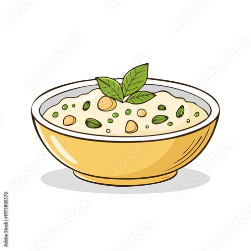 Bowl of creamy porridge or oatmeal topped with peas, nuts, and fresh green basil leaves
