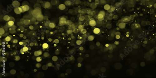 Glowing gold bokeh lights shine through water drops on a window to create a magical holiday texture with sparkling yellow and orange blur