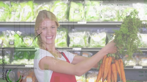 Smiling woman holding carrots in grocery store with data analysis animation over