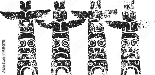 four traditional totem poles with intricate native carvings and bird figures standing side by side