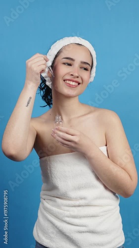 Young woman applying face serum with dropper for skin care