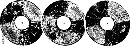three old cracked vinyl records with visible scratches and damage