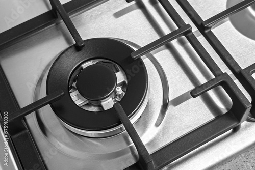 Vászonkép Top down close up of a modern stainless steel gas hob burner with cast iron grat