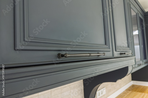 Schilderij op canvas Dark grey kitchen cabinetry showing classic design and decorative metal handles
