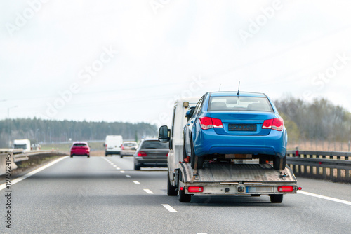 Photography Tow truck hauls a vehicle after a breakdown