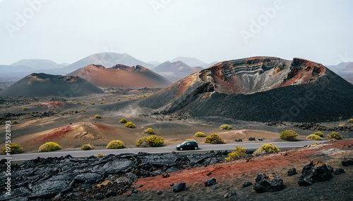 A lone dark car travels a narrow road through a vast, hazy volcanic landscape of craters and lava fields. Generative AI