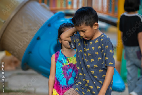 Little school boy enjoy slider outdoor playground park