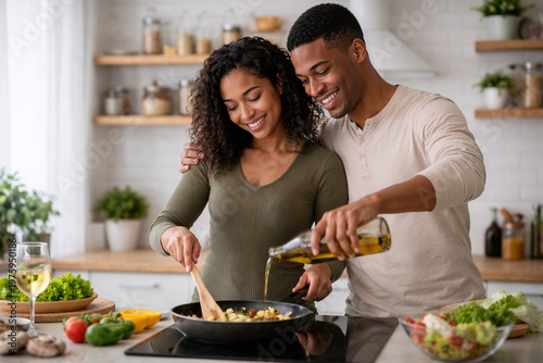 Happy couple cooking together in kitchen preparing healthy meal