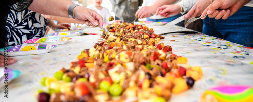fresh fruits and chocolate dipping sauce on table on easter party
