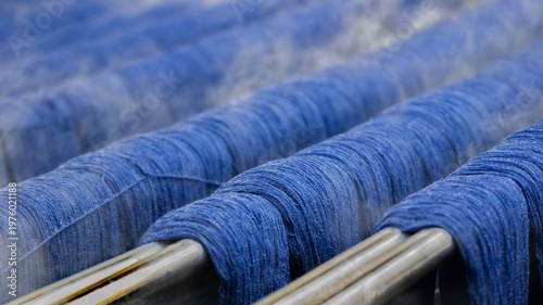 Canvas Print Blue Dyed Yarn Threads on Metal Rods in Textile Production Process