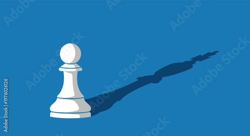 Small white chess pawn casting a shadow of a powerful king piece on blue background for ambition and potential concept.