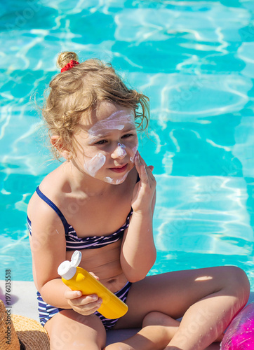 The child has sunscreen on his face. Selective focus.