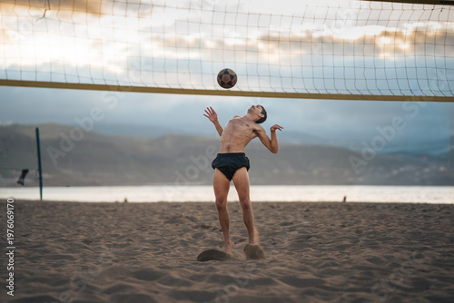 young man playing footvolley in Las Canteras beach. Las Palmas de Gran Canaria. Canary Islands. Spain.
