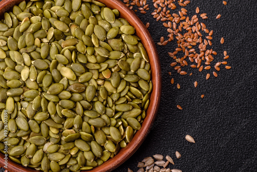 Fototapeta premium Shelled pumpkin seed kernels, salted, roasted, or raw, are a healthy ingredient. Pumpkin seeds