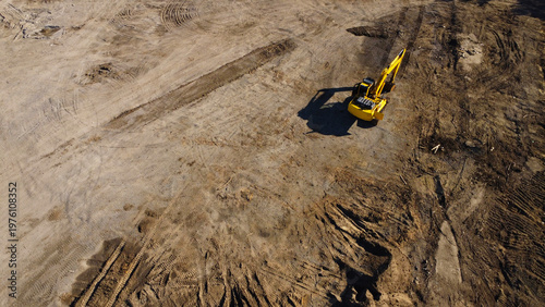 Aerial View of a Yellow Excavator Working on a Construction Site