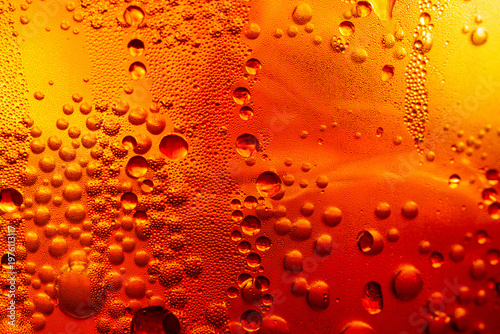 A macro shot of a cola drink showing cold condensation droplets on an amber-colored glass surface,Close-up macro photography of fresh water droplets and condensation on a chilled amber or orange.