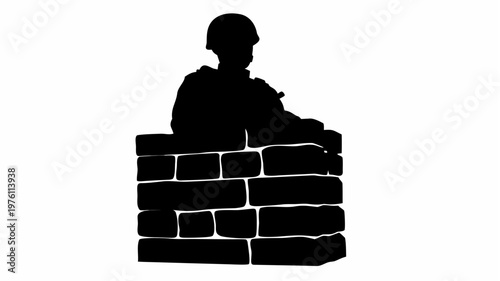 Silhouette of soldier standing guard behind a brick wall vigilance concept security and protection symbol