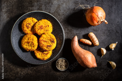 Raw vegetables on textured dark surface
