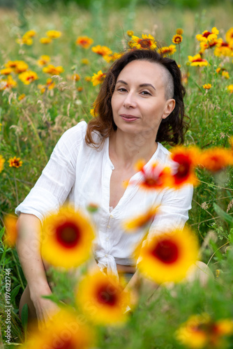 Woman Surrounded by Vibrant Sunflowers