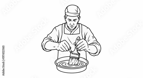 A person in a cap and apron dips a brush in a shallow bowl of liquid