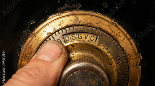 Close-up of a golden safe lock dial on a heavy steel vault door symbolizing security and protection on a dark green background, the code is DSGVO