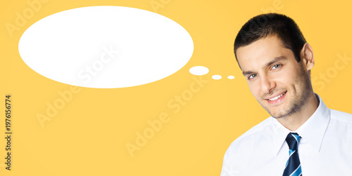 Portrait image - smiling business man wear corporate white shirt, stripes necktie tie. Young businessman isolate orange yellow background. White empty mockup think bubble, thinkbubble, thought float
