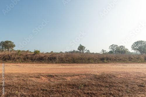 Side view of gravel road on top mountain. Landscape of dirt road in countryside with blue sky. Road background.