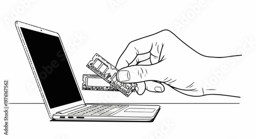 A hand holds two computer memory modules near an open laptop