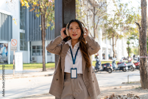 Asian businesswoman working on digital tablet with stylus outside modern building