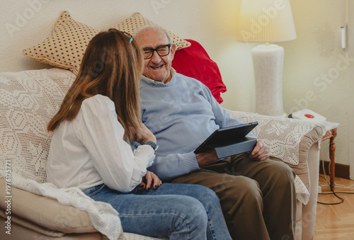 Fotografie Senior man with daughter enjoying technology together