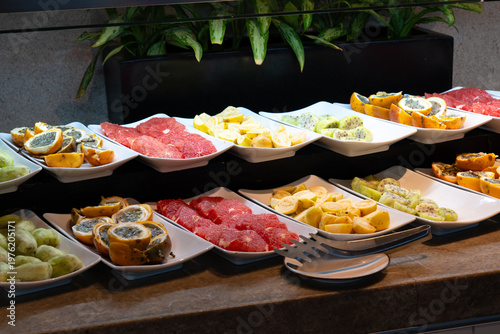 An eye-catching display of fresh, colorful fruits artfully arranged on platters, representing healthiness and vibrancy in a tempting culinary offering, enticing to the palate.