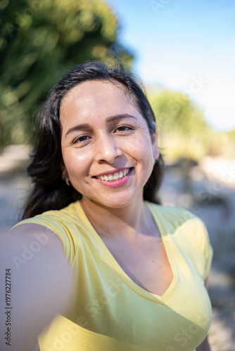 Woman smiling widely at camera, capturing a joyful personal moment during travel