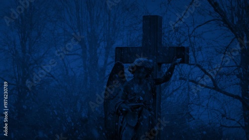 Cross Gravestone In Snowfall At Night