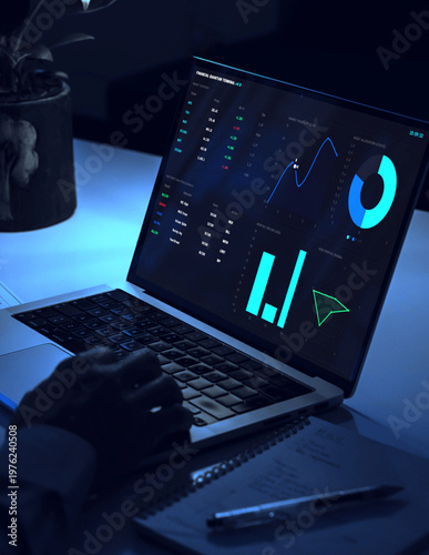 Man working late night at desk analyzing financial trading charts on laptop screen with energy utility bills for domestic budget economy investment concept