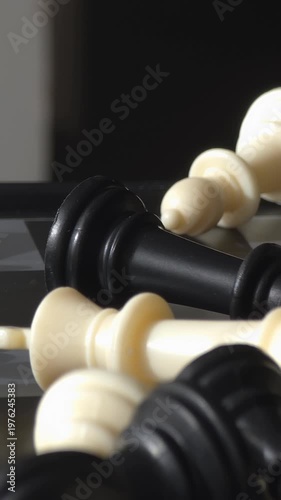 mutual loss mess: chess pawn win panning over mixed fallen chess pieces