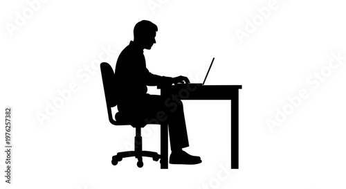 Silhouette of a Man Working on a Laptop Computer at a Desk