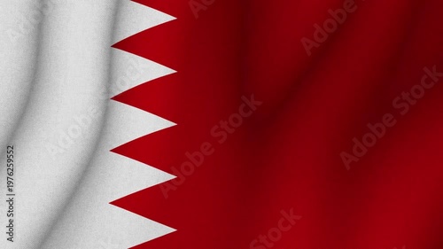 Flag of Bahrain waving in wind with red field and white serrated band. National identity patriotism and country symbol concept.