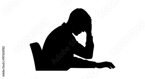 Silhouette of a Frustrated Person Holding Head While Sitting at a Desk