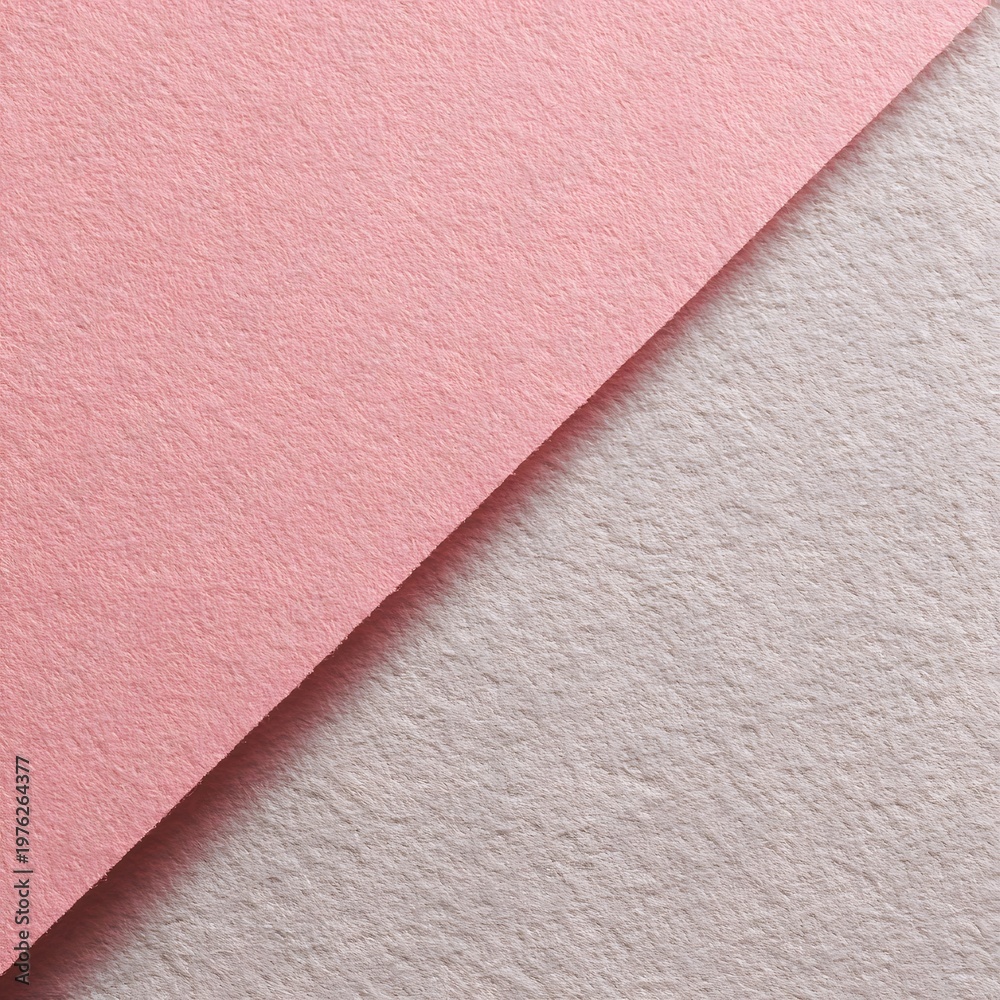 Fototapeta premium Gently overlapping planes of luxurious pink and understated grey felt fabric present a cozy and inviting textural background, ideal for textile artistry and warm design aestheticst