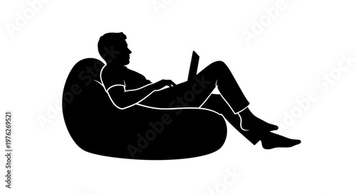 Silhouette of a Person Relaxing on Beanbag Chair Using a Laptop Computer